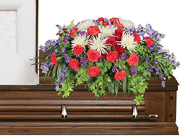 Casket spray with red, white, and purple flowers