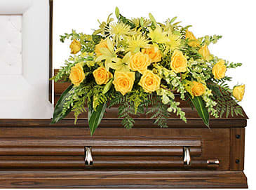 Yellow floral spray on a wooden casket