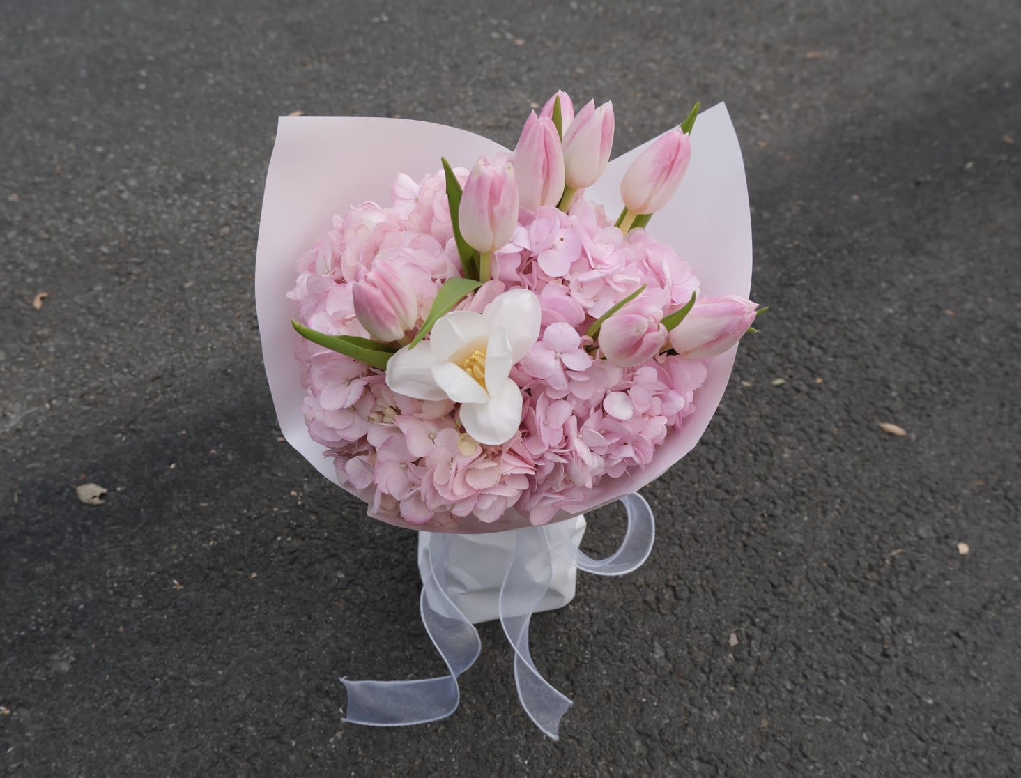 Pink Sorbet Kiss - A sweet and stylish treat! Our "Pink Sorbet Kiss" combines soft pink lisianthus, crisp white roses, and delicate purple accents. Wrapped in our airy cloud style, it’s a playful yet elegant bouquet perfect for birthdays or just because.