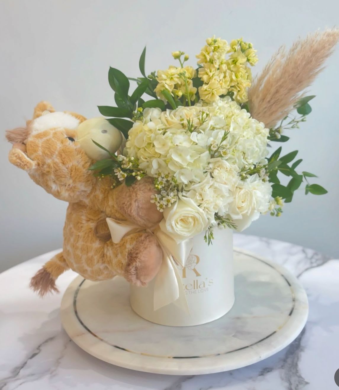 New Baby Arrangement  - Our "Rozella's" box, with giraffe teddy. neutral colors, mixed flowers. 