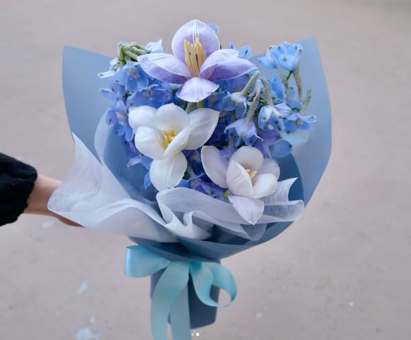 Blue Velvet Dream - A breath of fresh air! Our "Blue Ocean Kiss" features a stunning contrast of pure white roses and soft lisianthus against a bold, stylish blue wrap. It’s an elegant, modern, and refreshing gift that stands out from the crowd.
