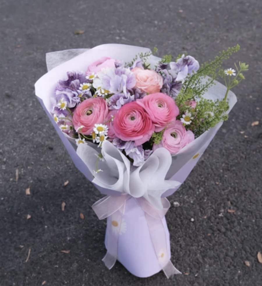 Enchanted Garden Bouquet - A vibrant burst of joy! Our "Berry Sorbet Kiss" features a lively mix of pink lisianthus, delicate purple accents, and fresh seasonal blooms. Wrapped in our airy signature cloud style, it’s a sweet and energetic gift for any happy occasion.