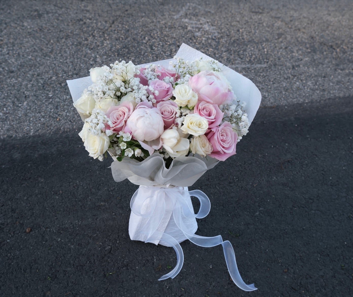 Peony Cloud Kiss - The ultimate floral luxury! Our "Peony Cloud Kiss" features breathtaking pink peonies paired with soft roses and airy baby's breath. Wrapped in our signature cloud style, it’s a lush, romantic, and unforgettable gift for someone truly special.