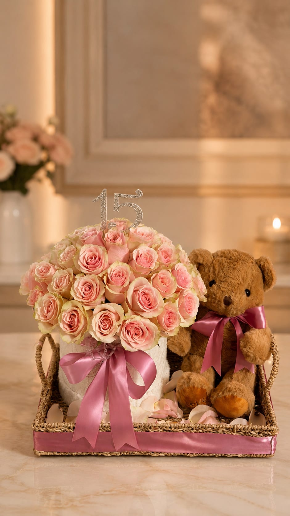 Blush Rose Teddy Birthday Basket - A soft dome of blush roses arranged in a woven basket makes a charming birthday or quinceañera gift that reads sweet and celebratory. This birthday flower arrangement features pale pink roses tightly clustered for a plush, tactile look, topped with a glitter number 15 for that milestone moment-perfect for birthdays, quinceañeras, anniversaries, or a "thinking of you" surprise that feels extra special.  The basket includes a small teddy bear tied with matching pink satin ribbon, plus two balloons (one clear iridescent and one printed "Happy Birthday" with daisies) that add height and festivity without overwhelming the roses. Colors run soft and feminine-pinks, whites, and a touch of purple and brown in the woven texture-so it also suits prom gifts, thank-you gestures, or a sweet "just because" moment.  Designed to make the recipient feel seen and celebrated, this arrangement is the kind of gift that reads thoughtful and festive on delivery. Ideal for sending congratulations, a Valentine's Day surprise, or a Women's Day tribute, it arrives ready to display in its decorative basket; simple care-fresh water and a cool spot-keeps the roses looking their best.