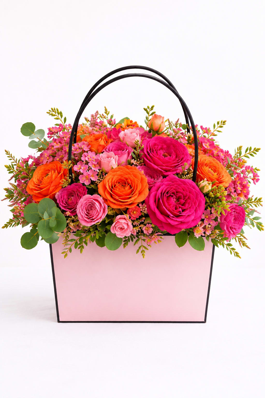 Sun Kissed Garden  - a vibrant Garden -style arrangement designed in our signature blush floral tote.Filled with luxurious roses, delicate accent blooms, and fresh greenery in glowing shades of pink, coral, peach, and orange. Cheerful, elegant, and full of summer energy, this arrangement feels like a warm sunset in bloom- perfect for birthdays, celebrations, or simply brightening someones day.