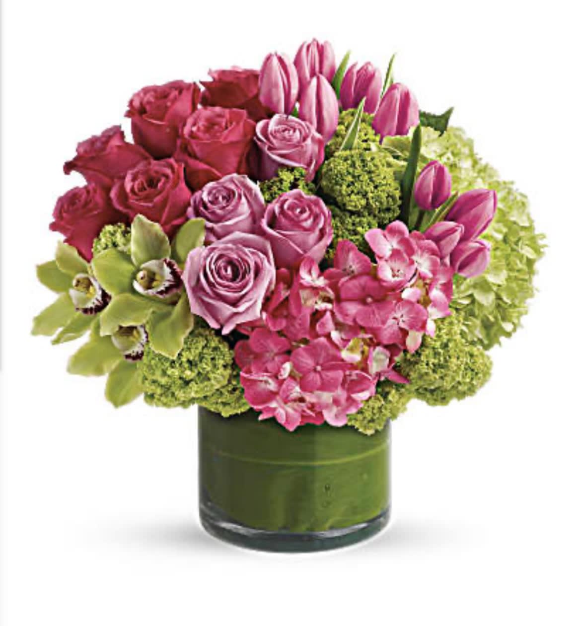 Pink roses and tulips arranged in a green glass vase