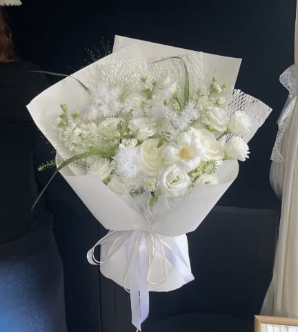 White Velvet Whisper - Simply divine! Our "Pure White Cloud" bouquet blends premium white roses and delicate lisianthus with a sprinkle of airy baby’s breath. Wrapped in our signature cloud style, it’s an elegant, clean, and heartfelt gift for any celebration.