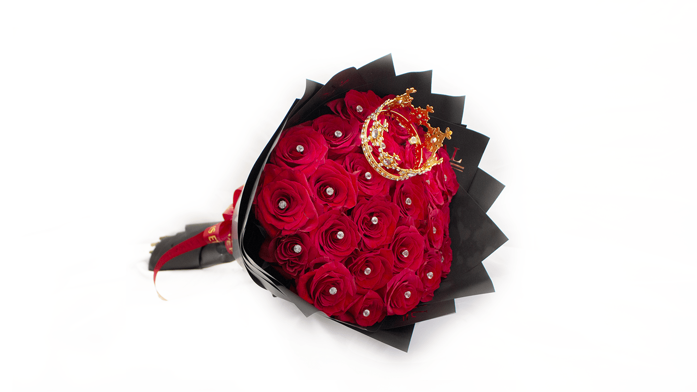 Bouquet of red roses wrapped in black paper with a gold crown