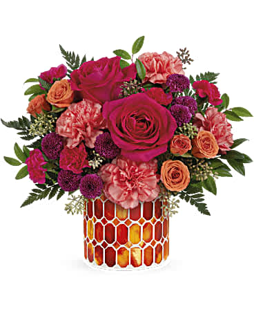 Pink and orange roses with carnations in a mosaic glass vase