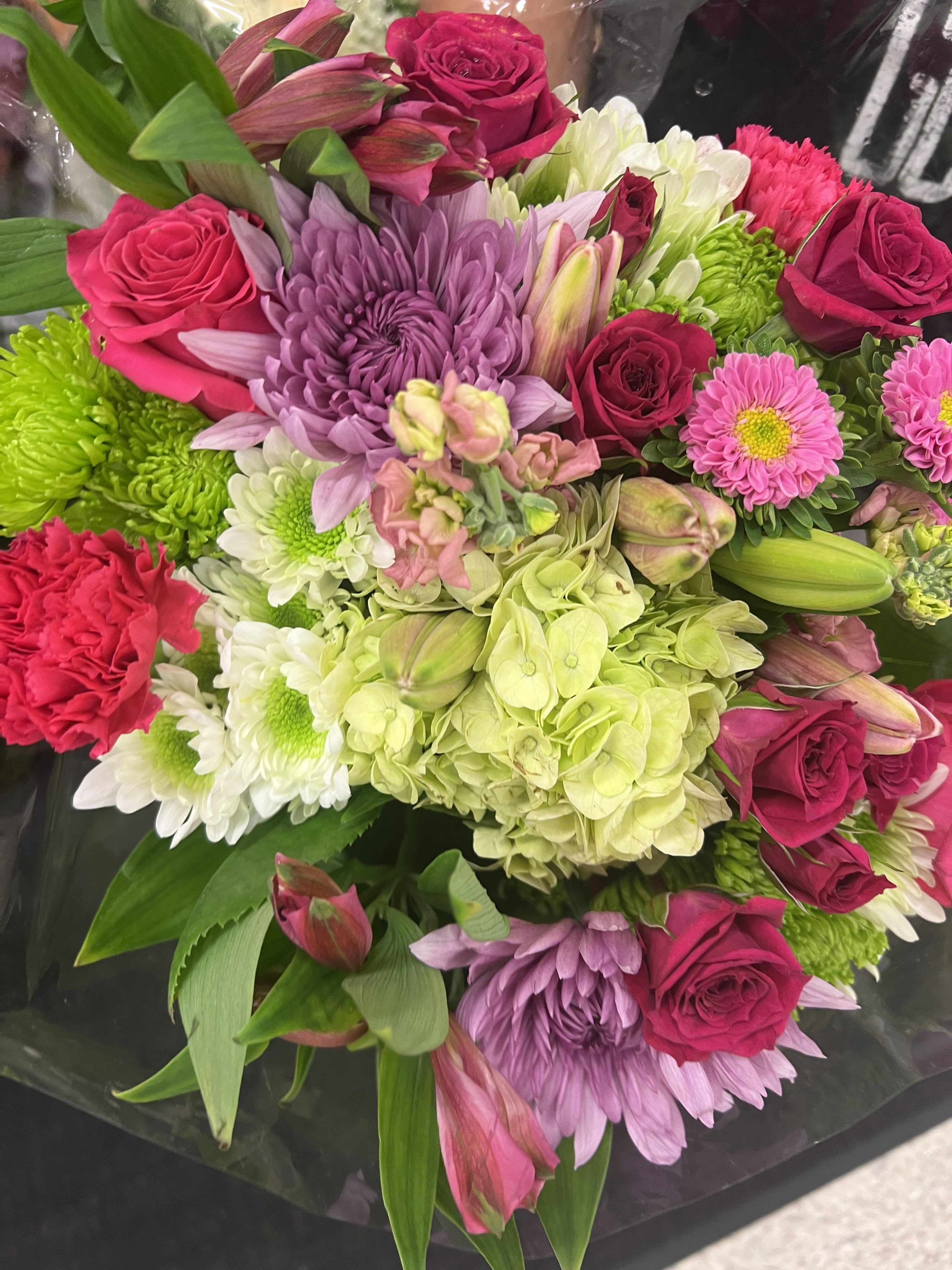 Mixed bouquet of pink roses, chrysanthemums, hydrangea, and lilies