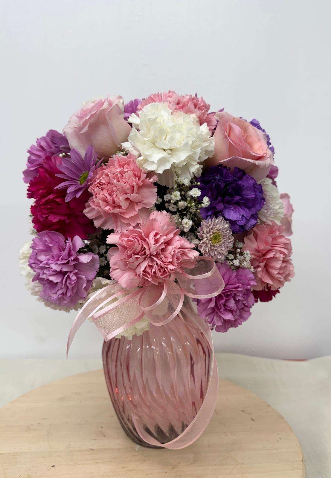 Cotton Candy (with pink Roses) - Soft and divinely delicate, this perfect pastel bouquet is pretty as can be. Delivered in a classic ginger jar, the graceful arrangement of   carnations, Roses Mom's.   welcome surprise on any occasion. 