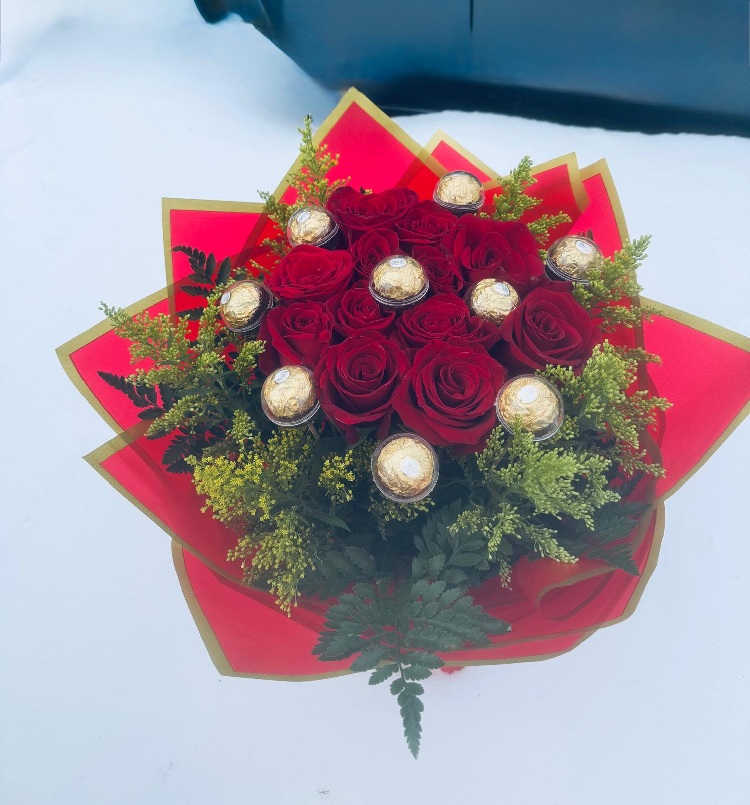 Red rose bouquet with gold-wrapped chocolates and red paper wrap