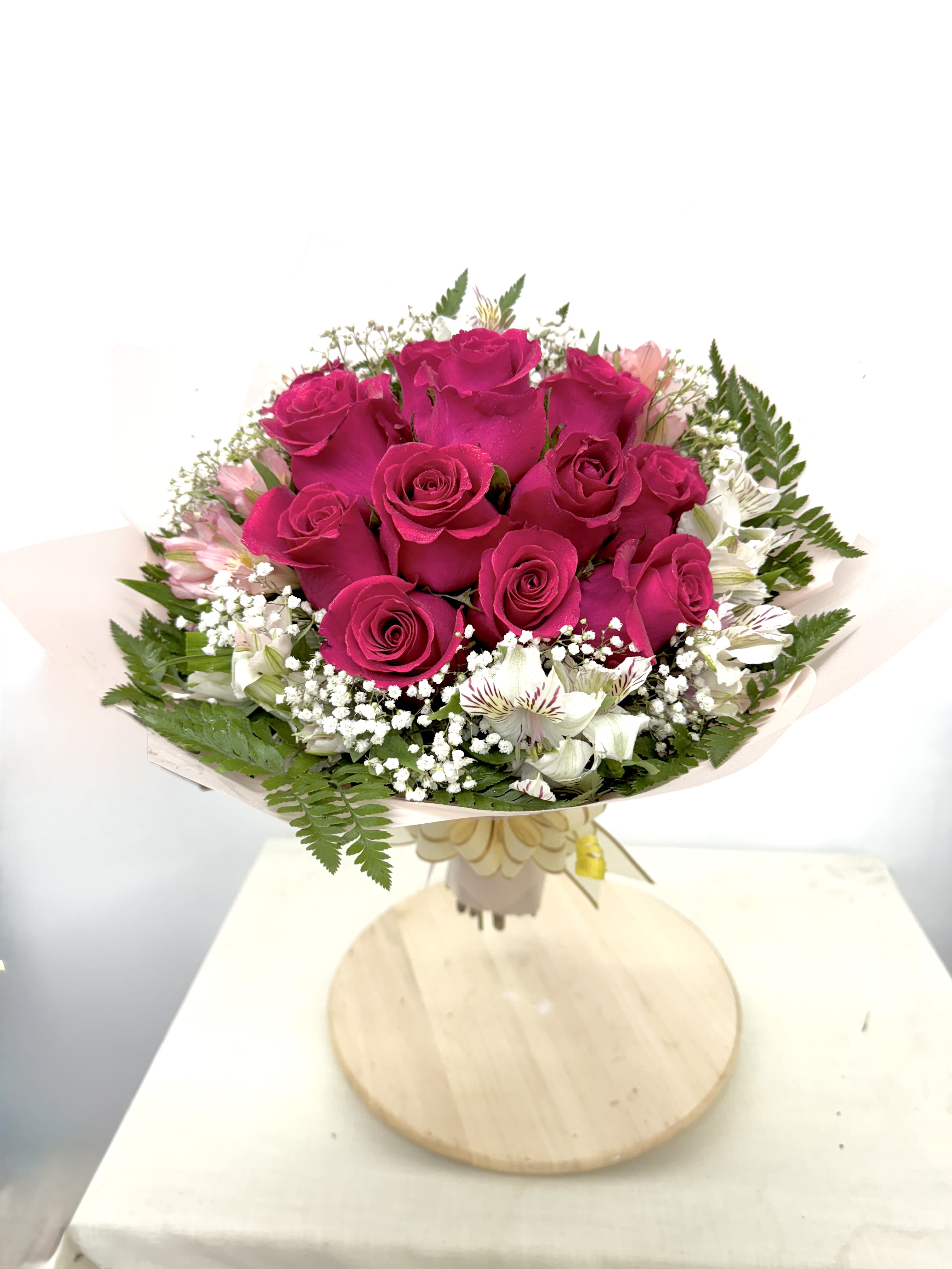 Bouquet of hot pink roses with white accent flowers