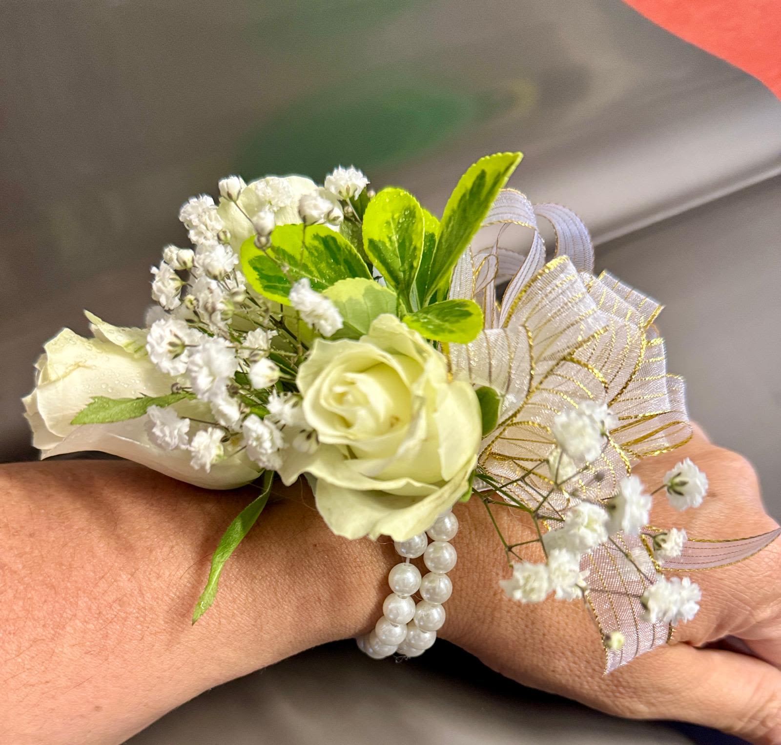 White rose wrist corsage with baby's breath and pearl bracelet