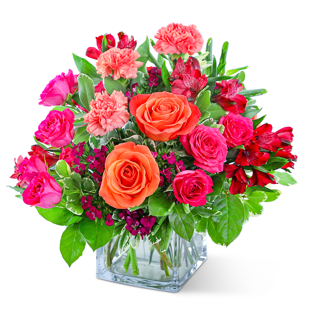 Mixed pink and orange flowers in a clear glass vase