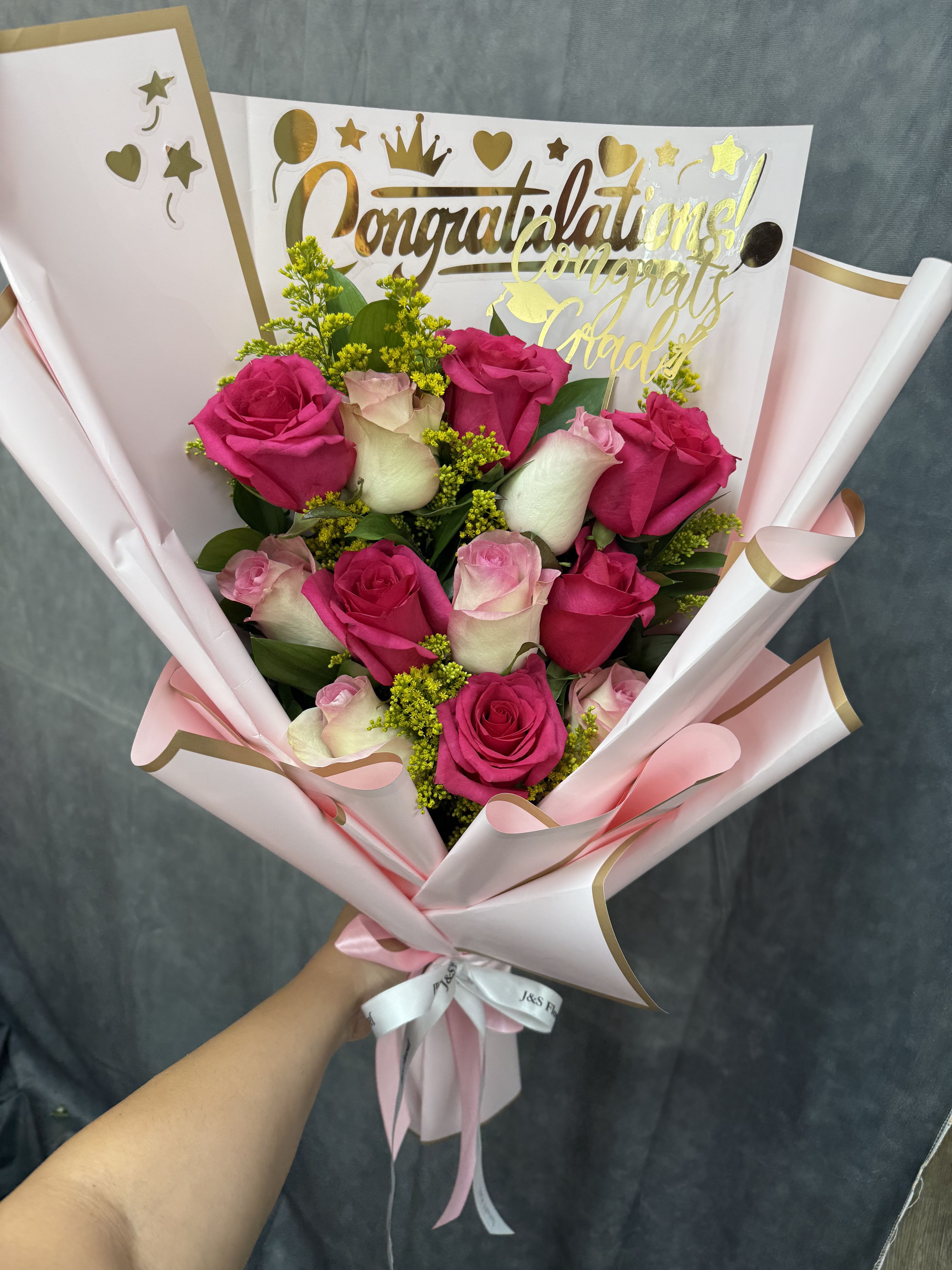 Congrats glow bouquet - Mix pink  roses with fillers and greenery, wrapped in pale pink paper with gold accents, ribbon, topper and chocolates-bright, feminine bouquet for celebrating achievements