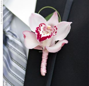 Pink orchid boutonniere pinned to a suit jacket