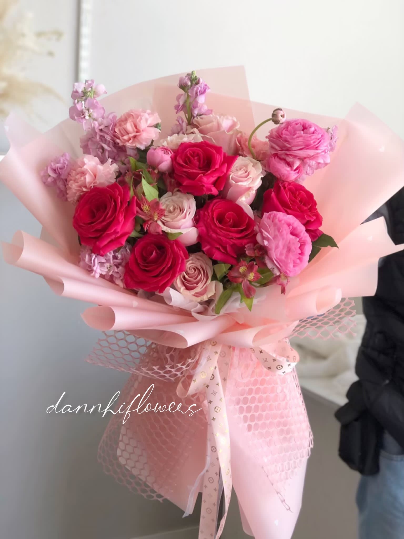 Vivid Romance Bouquet - The Vivid Romance Bouquet is a captivating ensemble of radiant hot pink and soft light pink roses, intricately arranged to evoke a sense of passion and tenderness. This bouquet captures the essence of love with its vibrant hues, creating a visual symphony that symbolizes both intensity and delicacy. Perfect for expressing deep emotions on Valentine’s Day, it’s a stunning testament to the beauty of love in full bloom. Photo is STANDARD size.  * All of our bouquets are wrapped with water in cellophane to keep the flowers fresh. If you need a vase, you can add it during checkout. Please let us know in the instructions if you prefer the bouquet without water.  Care Instructions: Please DO NOT remove the paper wrapping. The cellophane with water underneath acts as the vase. The next day, you can cut away the cellophane and gently hold all the flower stems with both hands inside the design paper, then place them in a vase with water. If possible, please change the water daily.  
