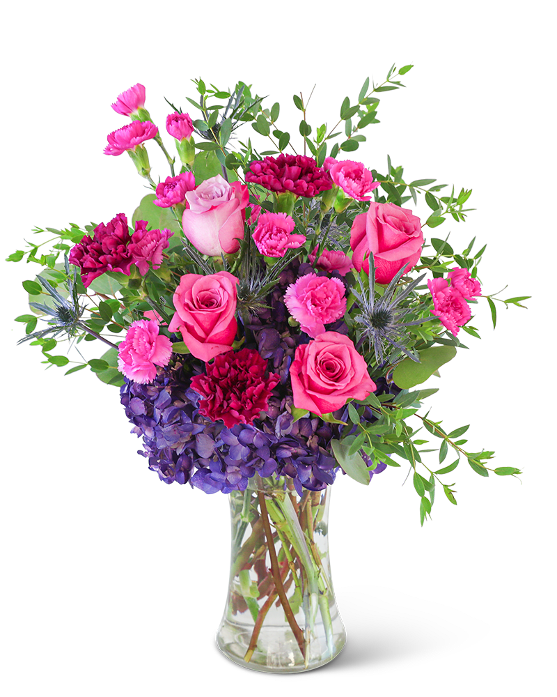 Love in London - Delight in the rich purple tones of one of our floral favorites, Love in London. A tall, chic vase with hydrangea, roses, carnations, and premium foliage makes up this beautiful floral design. This vibrant flower arrangement will brighten anyone's day and add a pop of color to any space. It would make a perfect Anniversary or Birthday gift for that special someone.