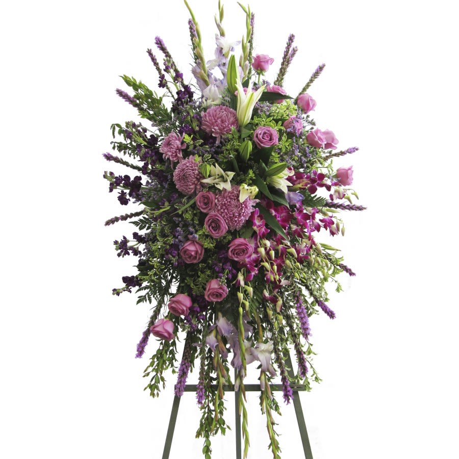 Tall standing floral spray with pink and purple flowers on an easel