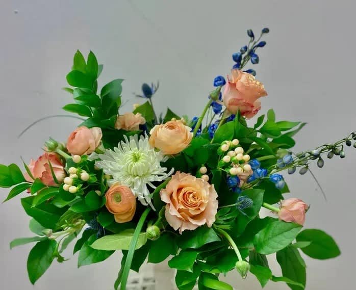 Peach roses and white chrysanthemum bouquet with blue accents