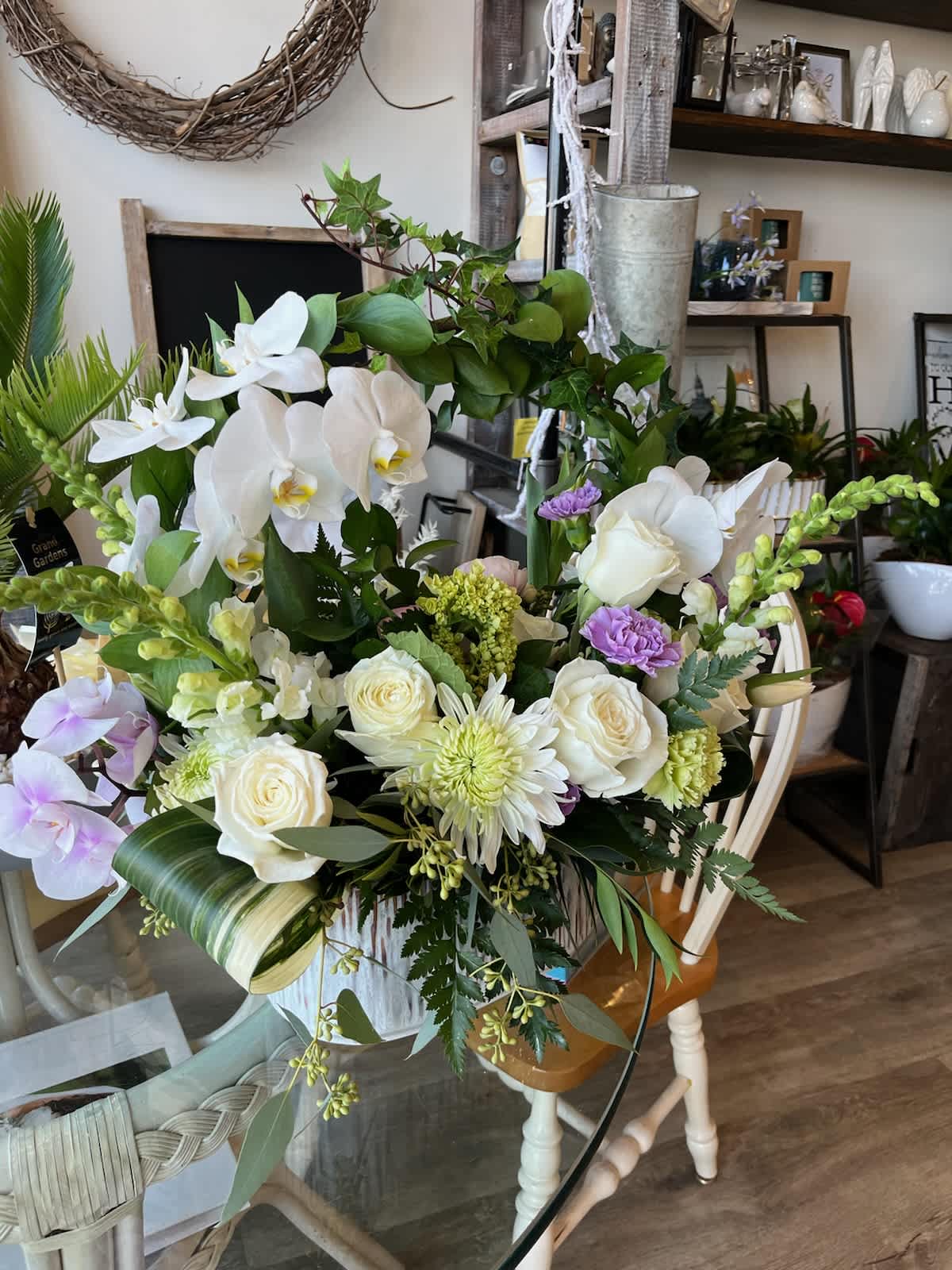 Large bouquet of white orchids and roses with lavender accents
