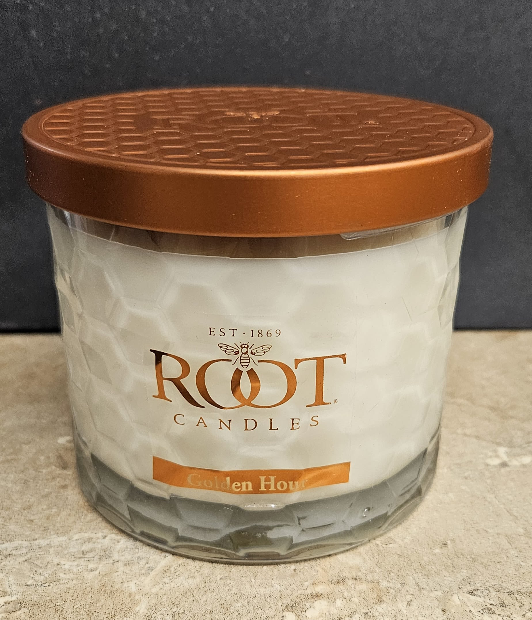 Root Candle Golden Hour 3 Wick - Warm, cozy and quietly refined - this Root Candle Golden Hour 3-wick makes a thoughtful gift for seasonal decor or a birthday that calls for comfort. As a home fragrance choice for autumn or everyday moments, the candle arrangement and occasion are clear: it's a gift that helps the person you're thinking of settle in and feel seen, whether for a hostess, friend, or loved one marking a milestone.  The candle sits in a clear faceted glass jar topped with a copper-colored metal lid; smooth white wax and a minimal Root Candles label keep the look clean while orange-brown accents lend that golden-hour glow. The three-wick format fills a room evenly, and the compact jar makes it easy to place on mantels, side tables, or bathroom counters as seasonal decor.  Perfect for sending warmth at Thanksgiving, as a thoughtful housewarming, or simply to say "I'm thinking of you," this candle arrives ready to use - no assembly required. Burn in a well-ventilated area, trim wicks to recommended length between uses, and enjoy long-lasting scent that complements cozy moments.