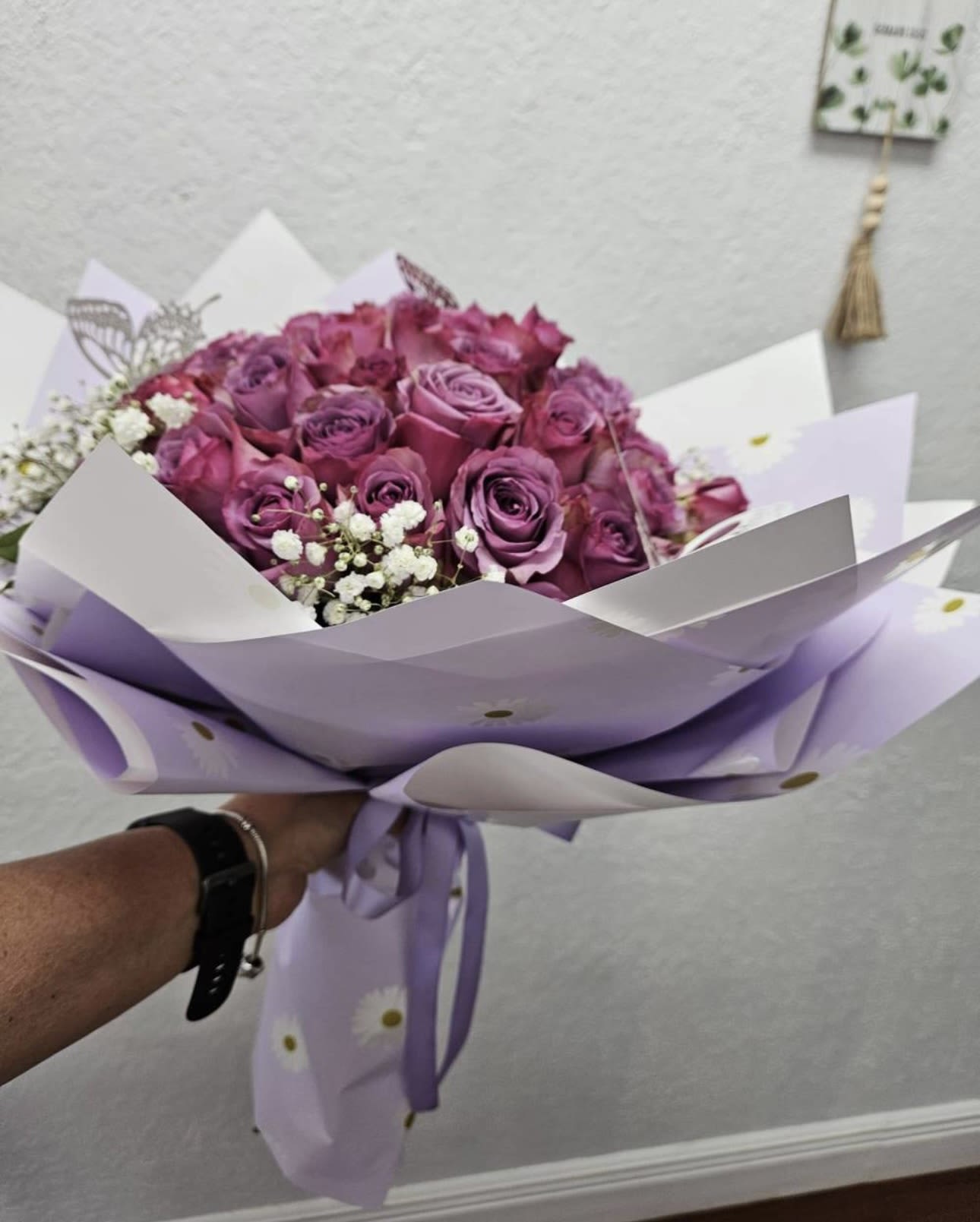 Bouquet of purple roses wrapped in lavender paper