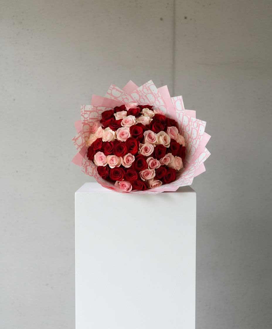 Bouquet of red and pink roses wrapped in pink paper