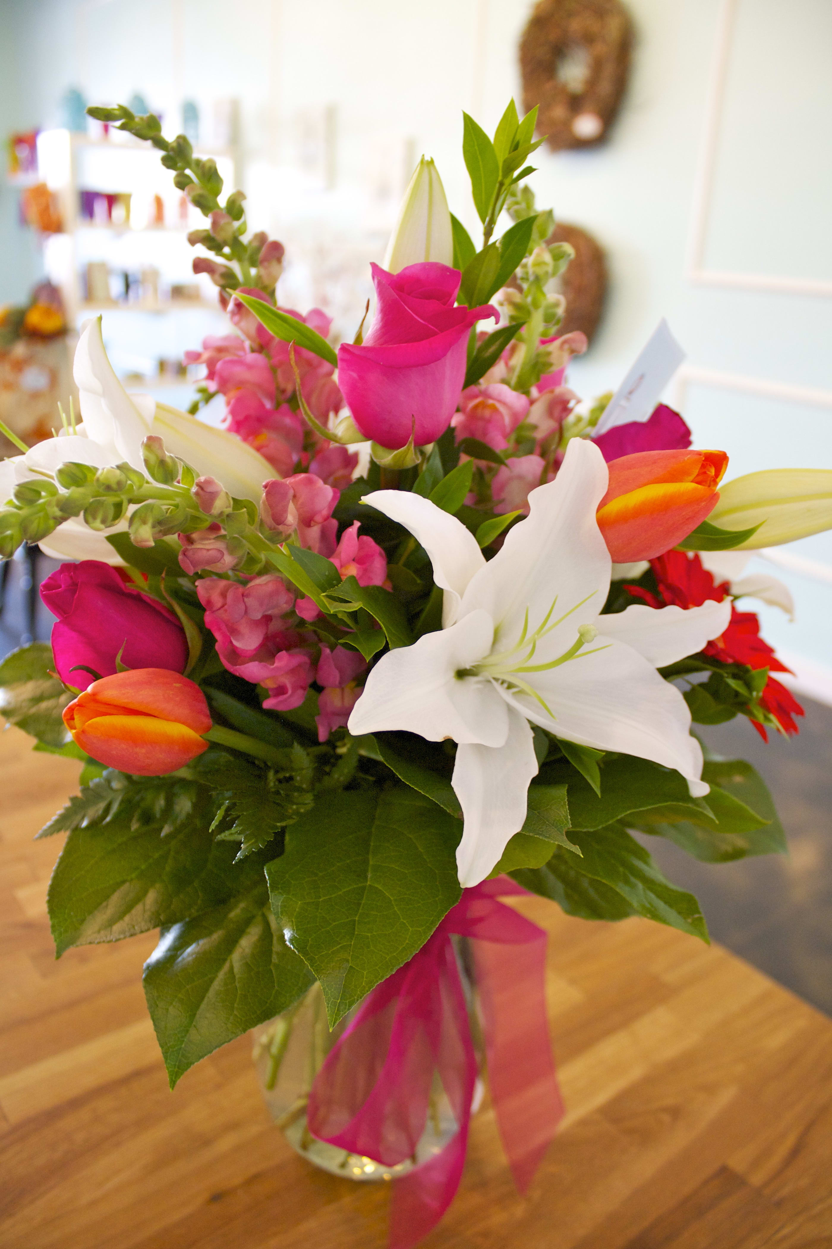 Brighten Your Day - This bright, happy arrangement is beautiful and fragrant...bring a little summer inside! Features oriental lilies, bright tulips, roses and gerbera daisies.  Please Note: Standard Delivery for this product occurs in the afternoon, between 2:30pm and 7pm. If you need it by a certain time, there is an option to select a timed window for scheduled deliveries.