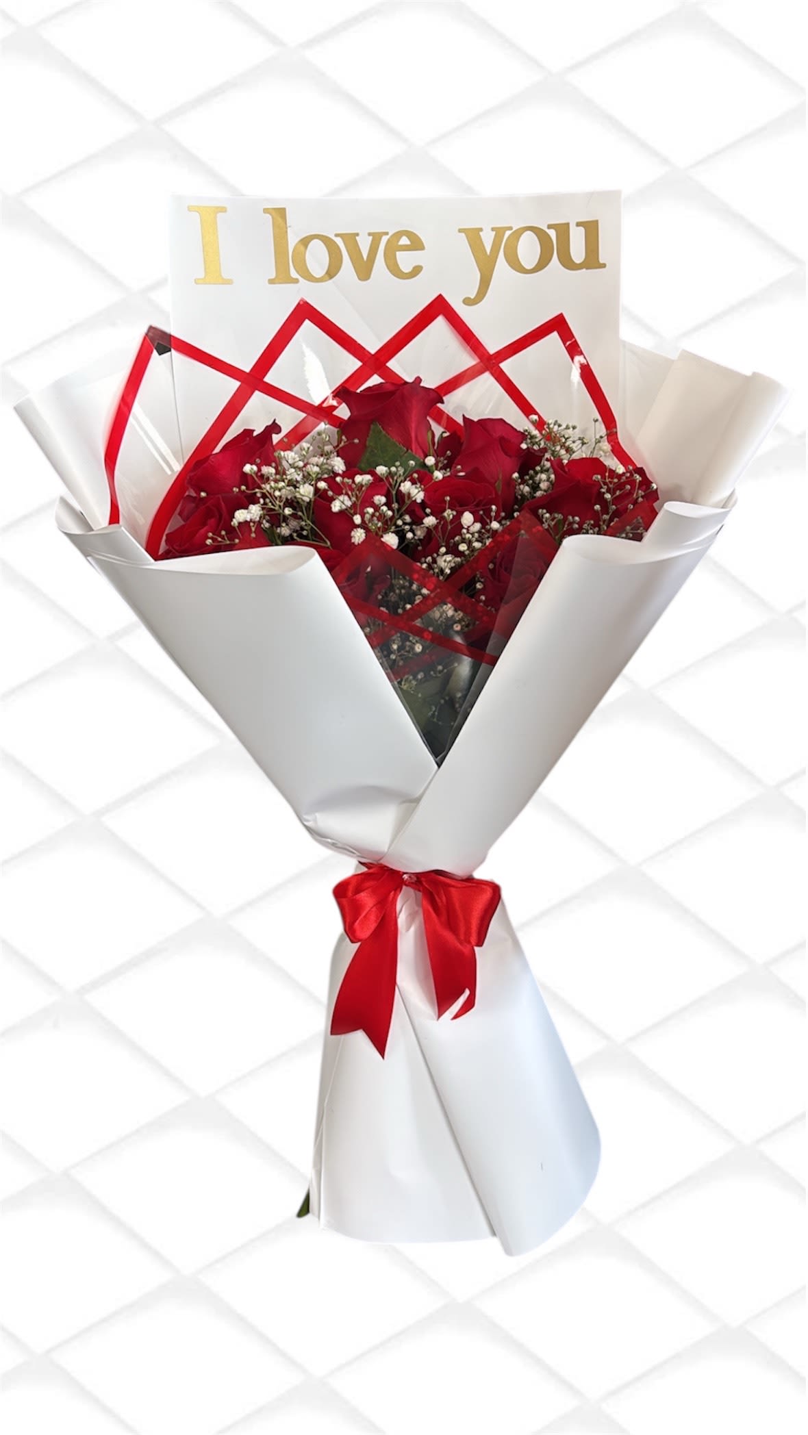 Red roses wrapped in white paper with a gold "I love you" card