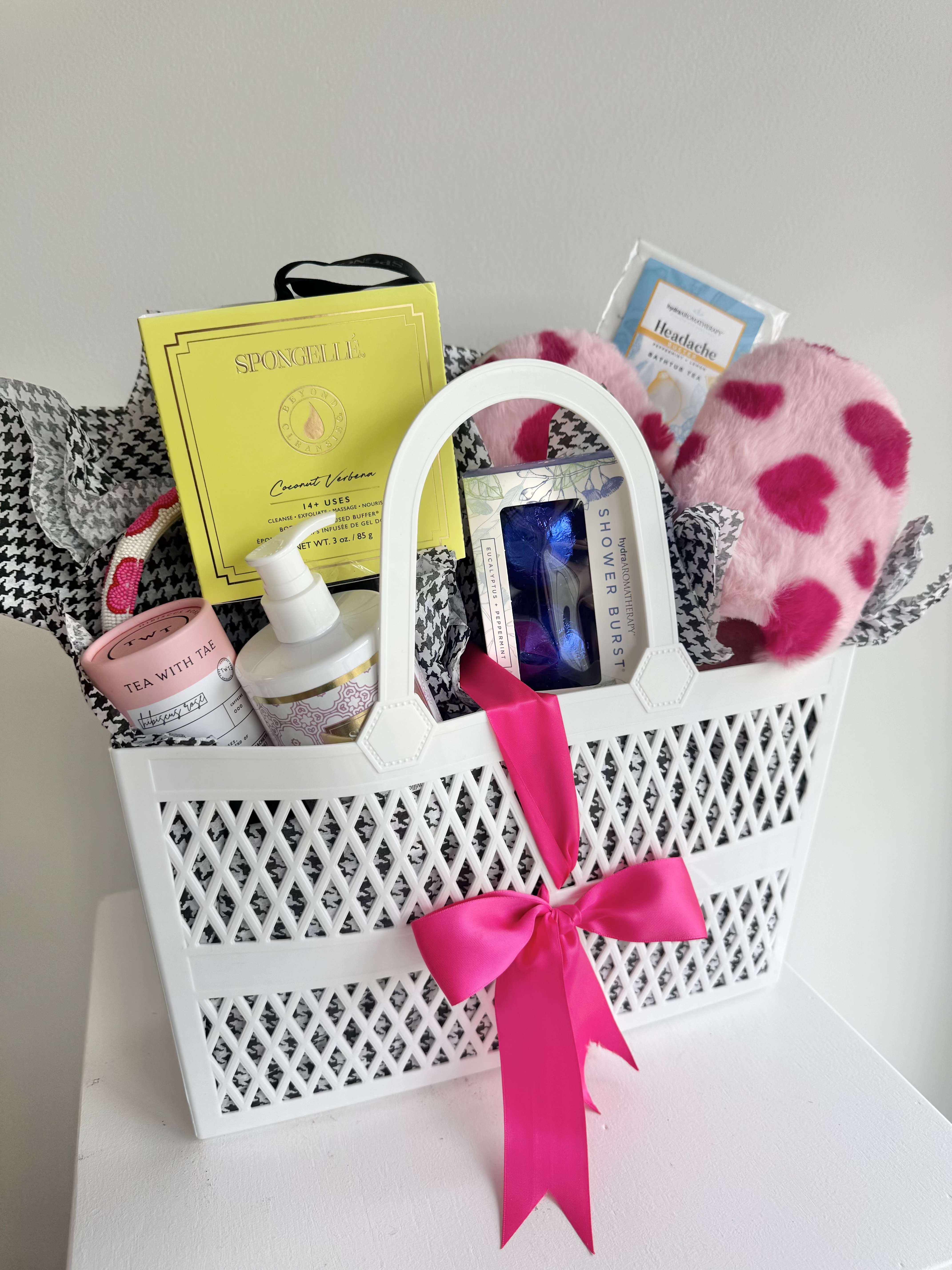 The Pampered Sweetie - The perfect bundle to pamper the woman in your life you call mom! Includes a curated selection of heart slippers, a heart headband, a box of 5 tea bags, a Spongellé lotion, a Spongellé body buffer, a pair of shower burst tablets, and package of bath tea.