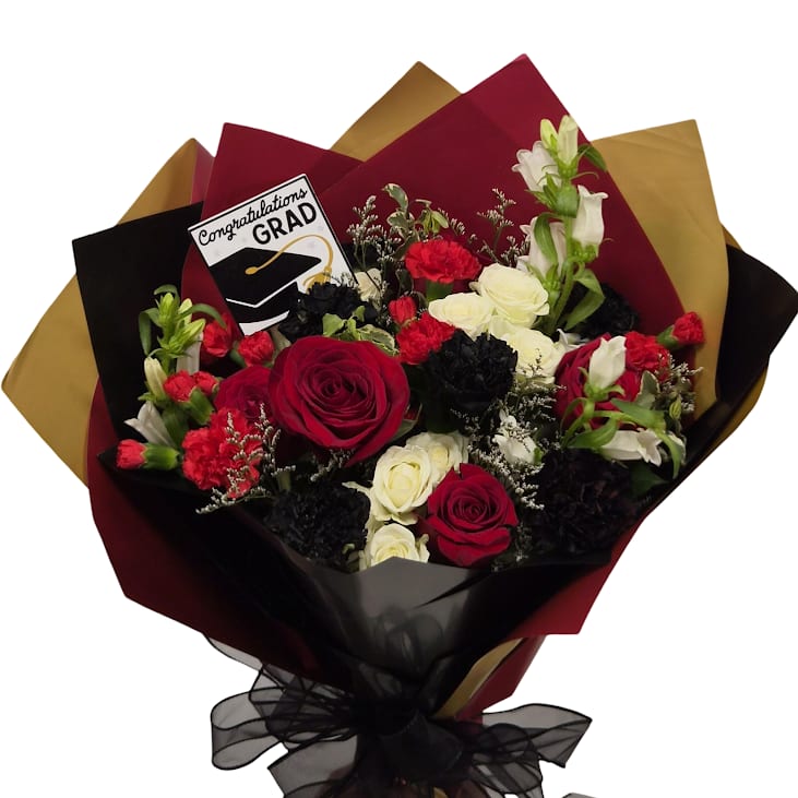 Diploma Season Cellowrap - Bold burgundy and black with bright white highlights create a formal, celebratory bouquet made for graduation and congratulations. Designed with Chico State University colors in mind but perfect for any graduate, this arrangement reads as confident and photo-ready-the high-contrast palette makes the recipient feel honored and spotlighted at the moment that matters.  Wrapped in layered burgundy, black, and gold decorative paper and finished with a sheer black ribbon, the arrangement comes with a graduation card and is presented on a wet sponge that should keep stems fresh for a few hours. Wrapped perfectly for ready-to-go pictures, it's an ideal pick when you want the graduate to look and feel celebrated the minute they step into the spotlight.