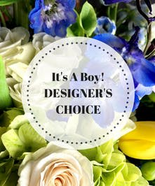 Mixed bouquet with blue, white, and green flowers and a baby boy card