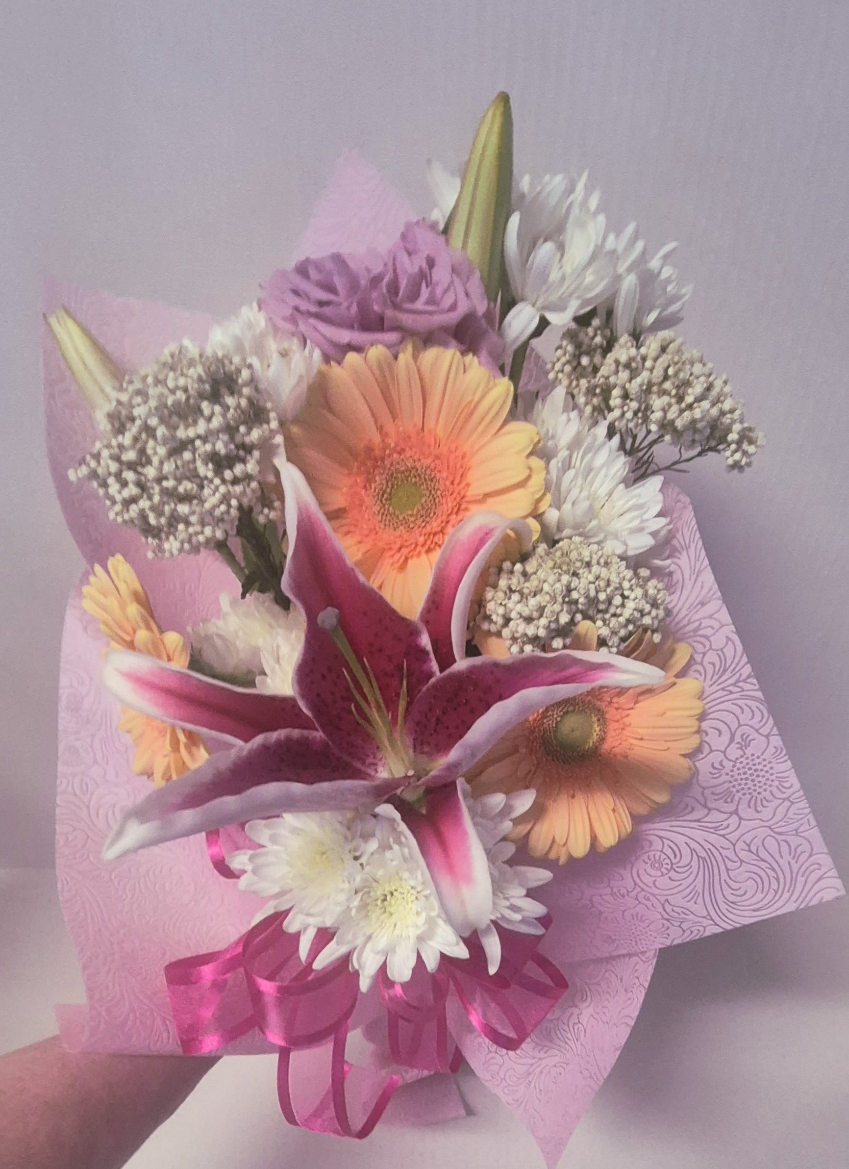 Mixed Flower Wrap starting at $55 - Assorted flowers which may vary, presented in a designer embossed floral wrap with ribbon, ready for arranging. Perfect for graduations, gifts  and event presentations.