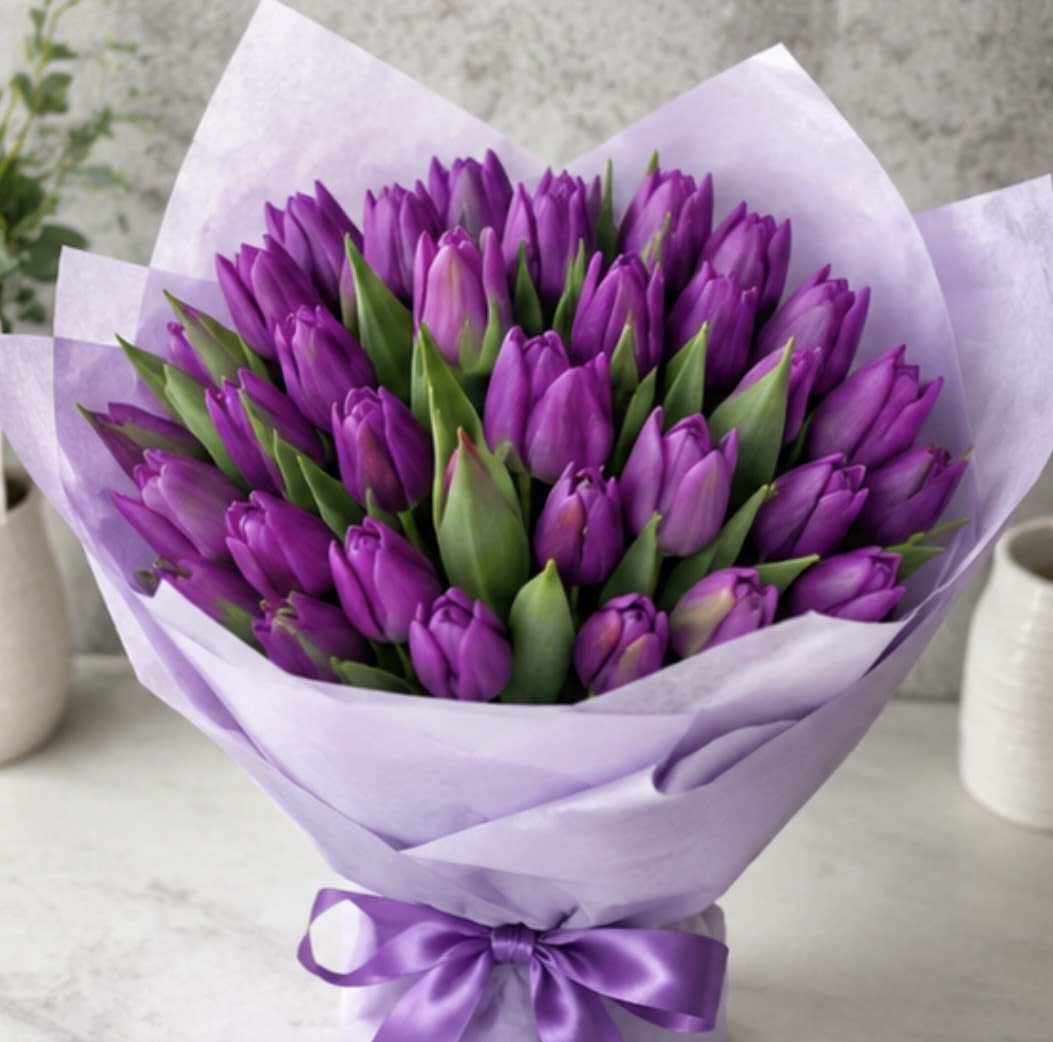 Lavender Dream Tulip Bouquet - An elegant arrangement of premium purple tulips wrapped in luxurious lilac paper and finished with a matching satin ribbon. Sophisticated, vibrant, and handcrafted to create unforgettable moments.   Fresh premium tulips  Elegant modern wrapping  Perfect gift for any occasion  Available for online order &amp; delivery  Surprise someone special with timeless floral elegance.