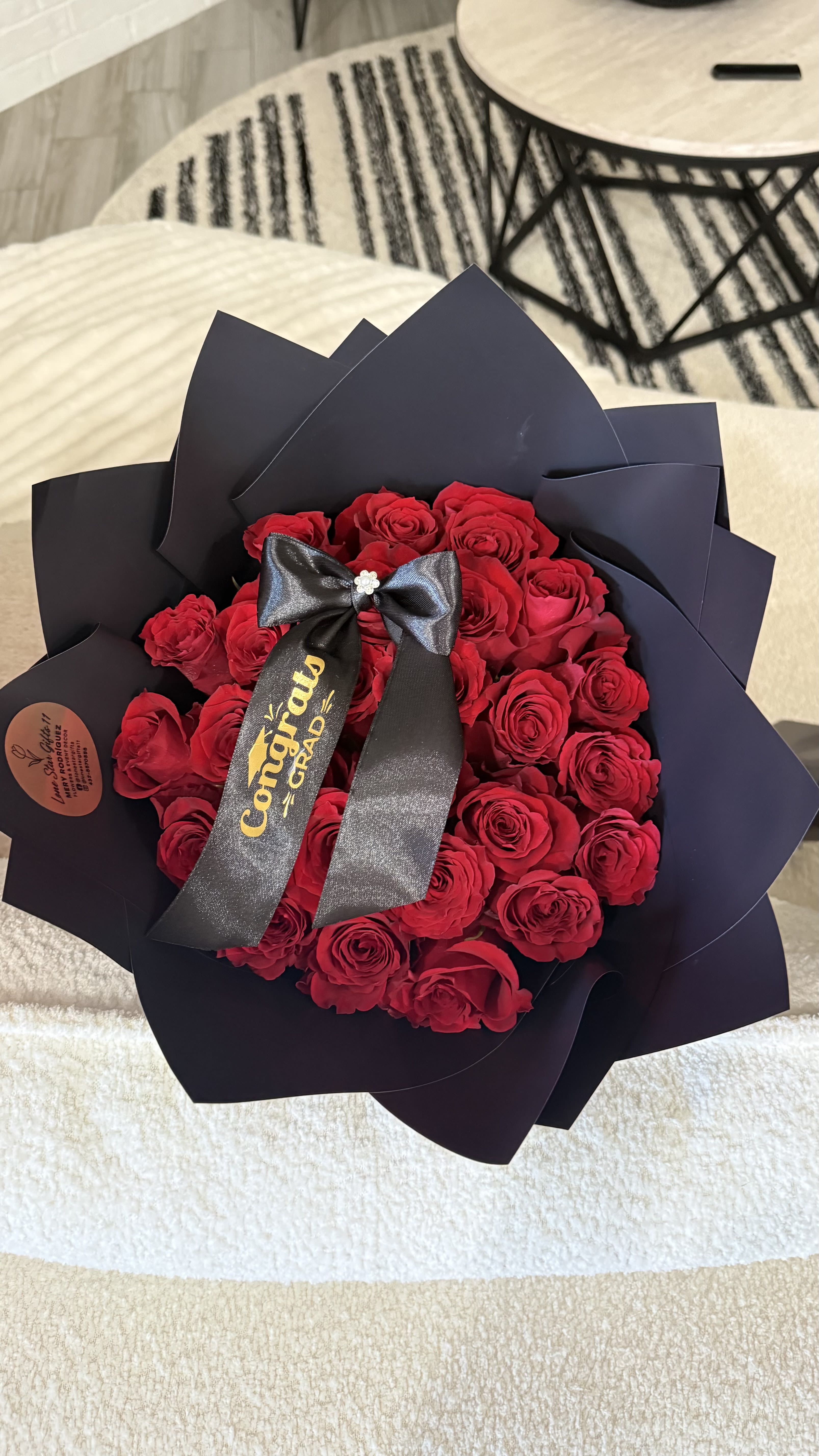 Grad Bouquet  - Celebrate their big achievement with a timeless Graduation Bouquet featuring two dozen fresh roses and a personalized “Congrats Grad” ribbon. Available in your choice of elegant black or soft pink wrapping paper for the perfect graduation touch. 