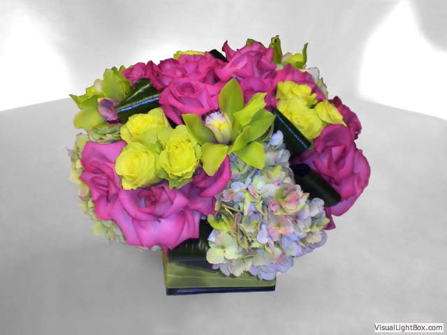 Pink and yellow rose bouquet with hydrangeas in a square vase