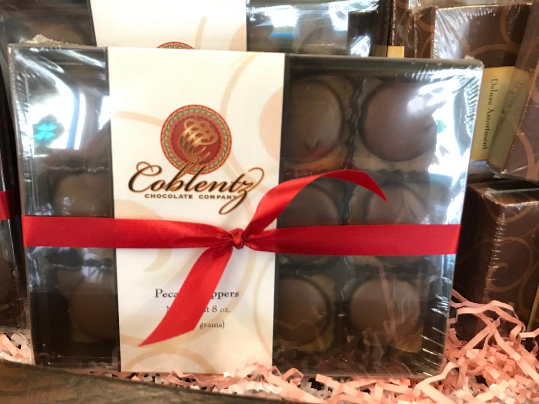 Boxed chocolates tied with a red ribbon