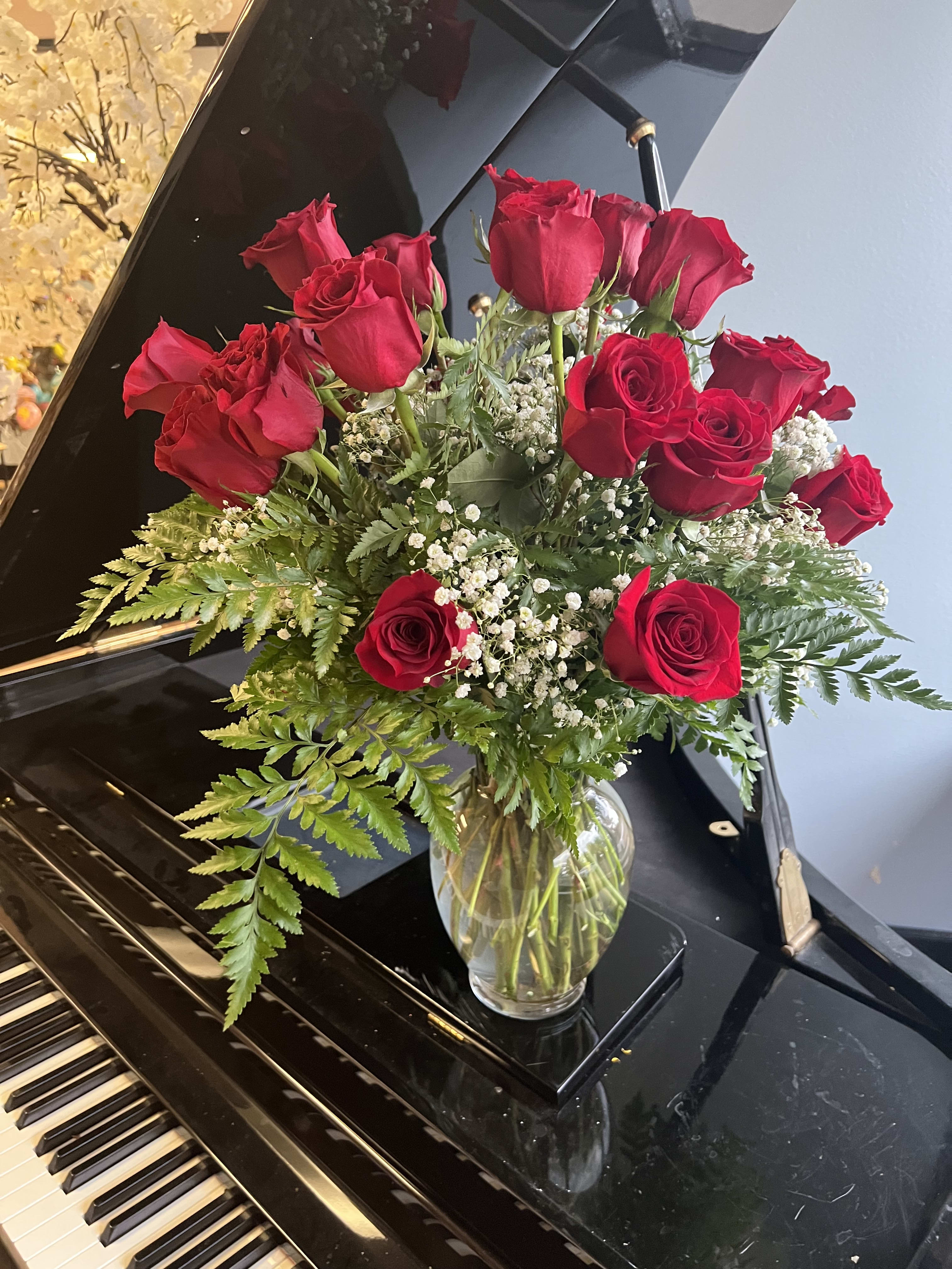 25 red roses with fillers in vase - 2 dozen roses with greens and babies breath in a vase. 