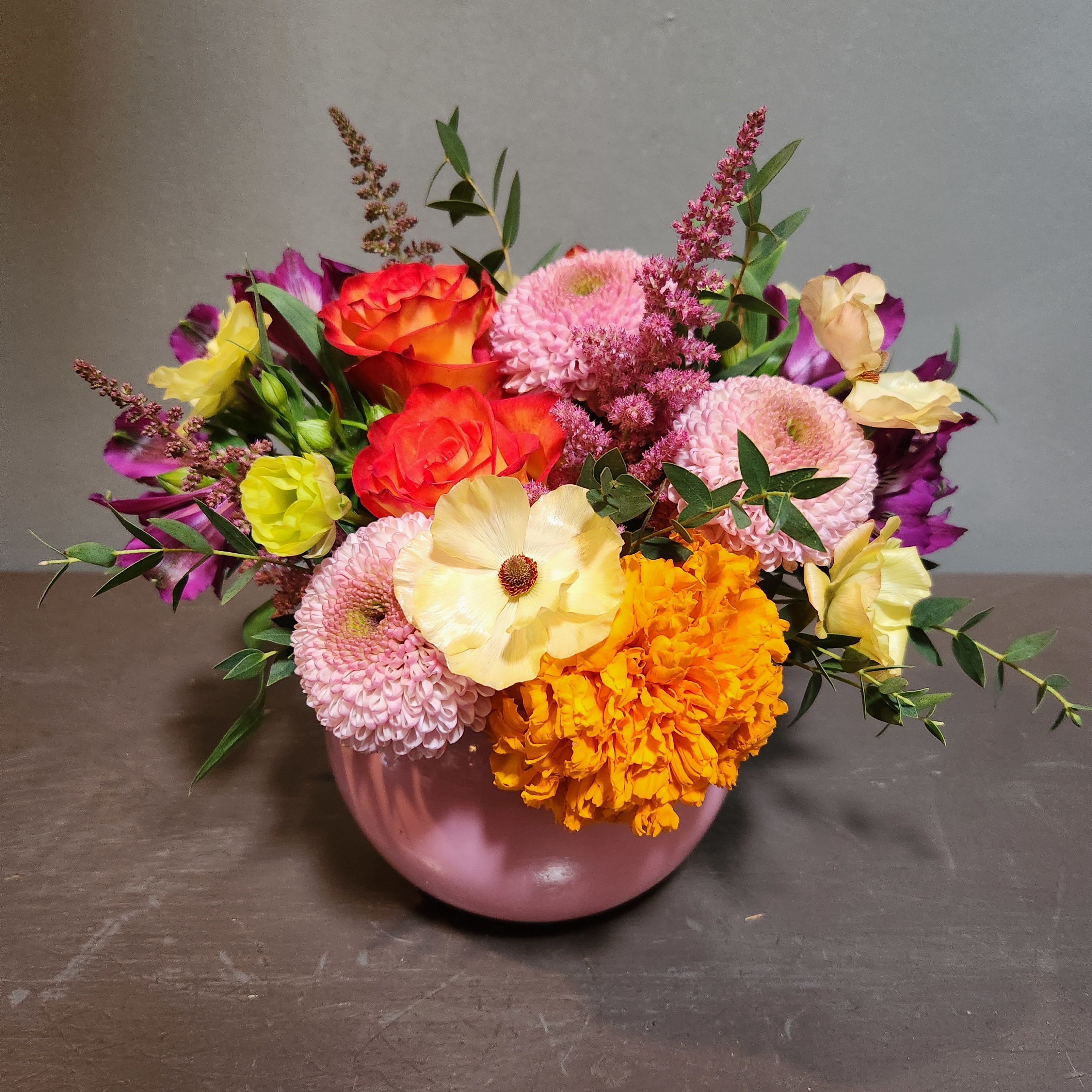 A Little Pop of Sunshine - A bright pop of fresh flowers to brighten your day.  Measures approx. 10"Tx11"W and arrives in a pink glass vase.