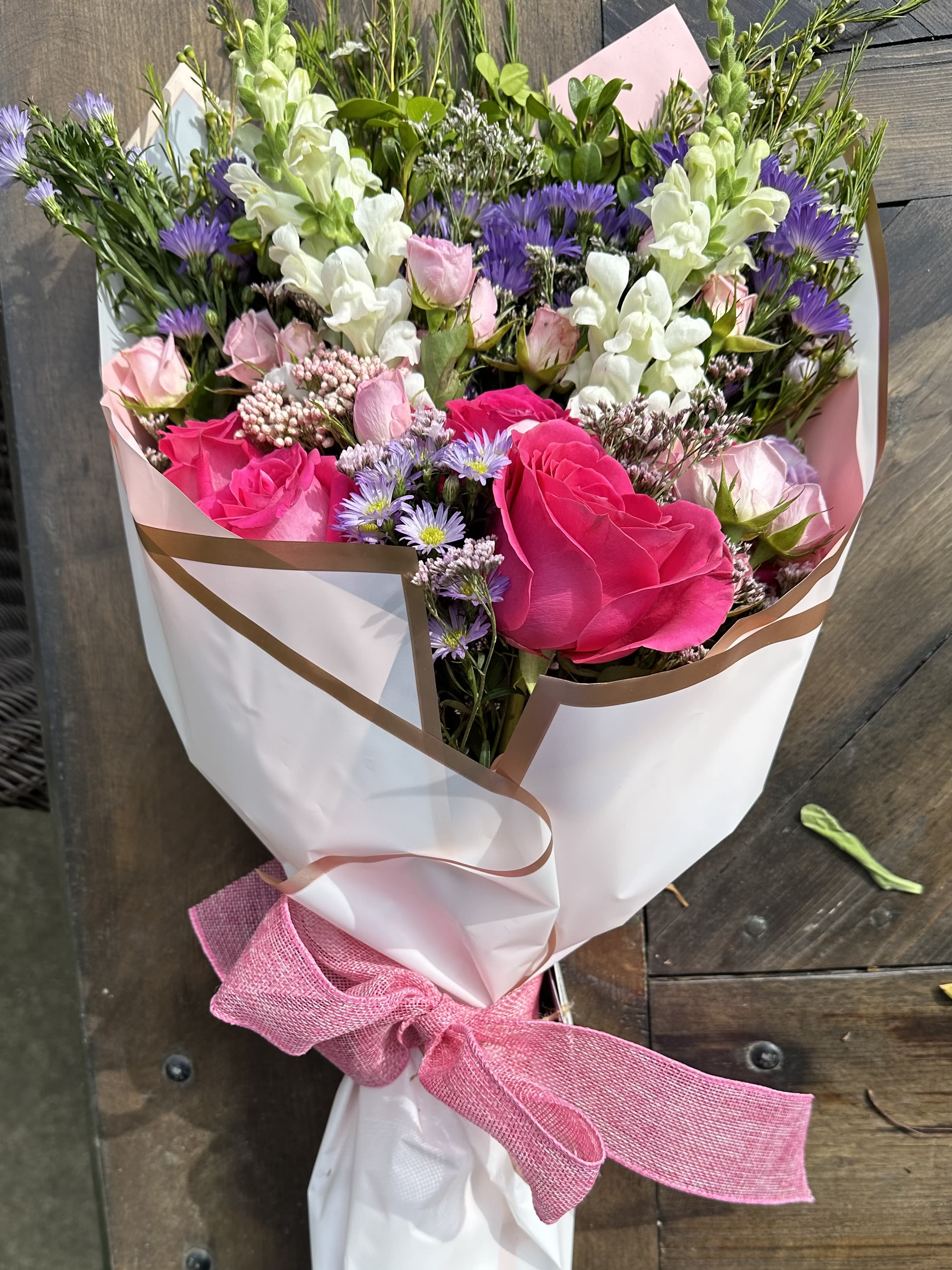 Wrapped Designer's Choice Bouquet - A gorgeous large bouquet of seasonal blooms filled with a variety of colors and textures. Bouquet is ready to be placed in your favorite vase. 
