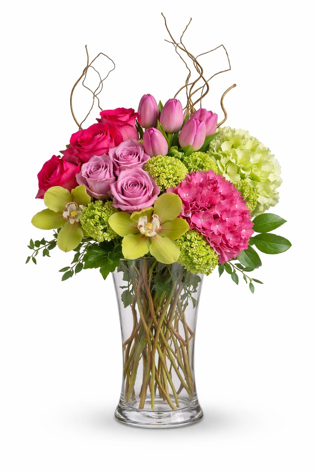 Pink roses and tulips in a clear glass vase with green hydrangeas
