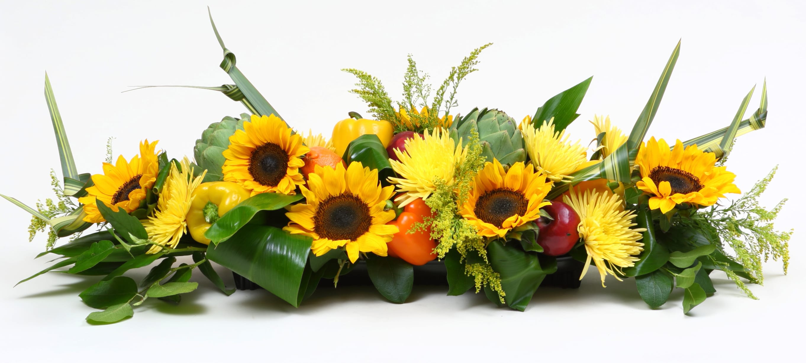 Low floral centerpiece with sunflowers and gourds in a rectangular container