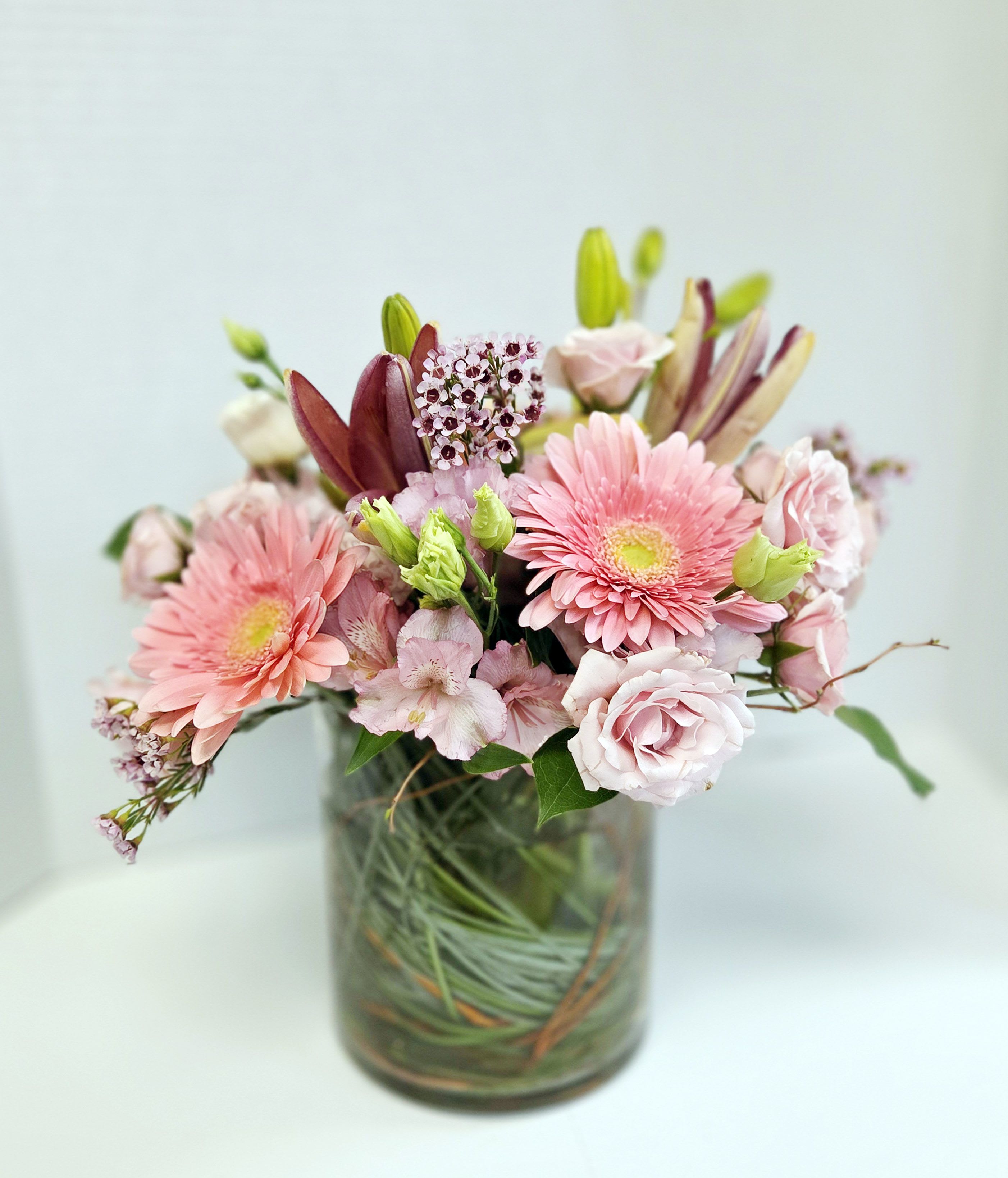 Pink and white mixed flower bouquet in a glass vase