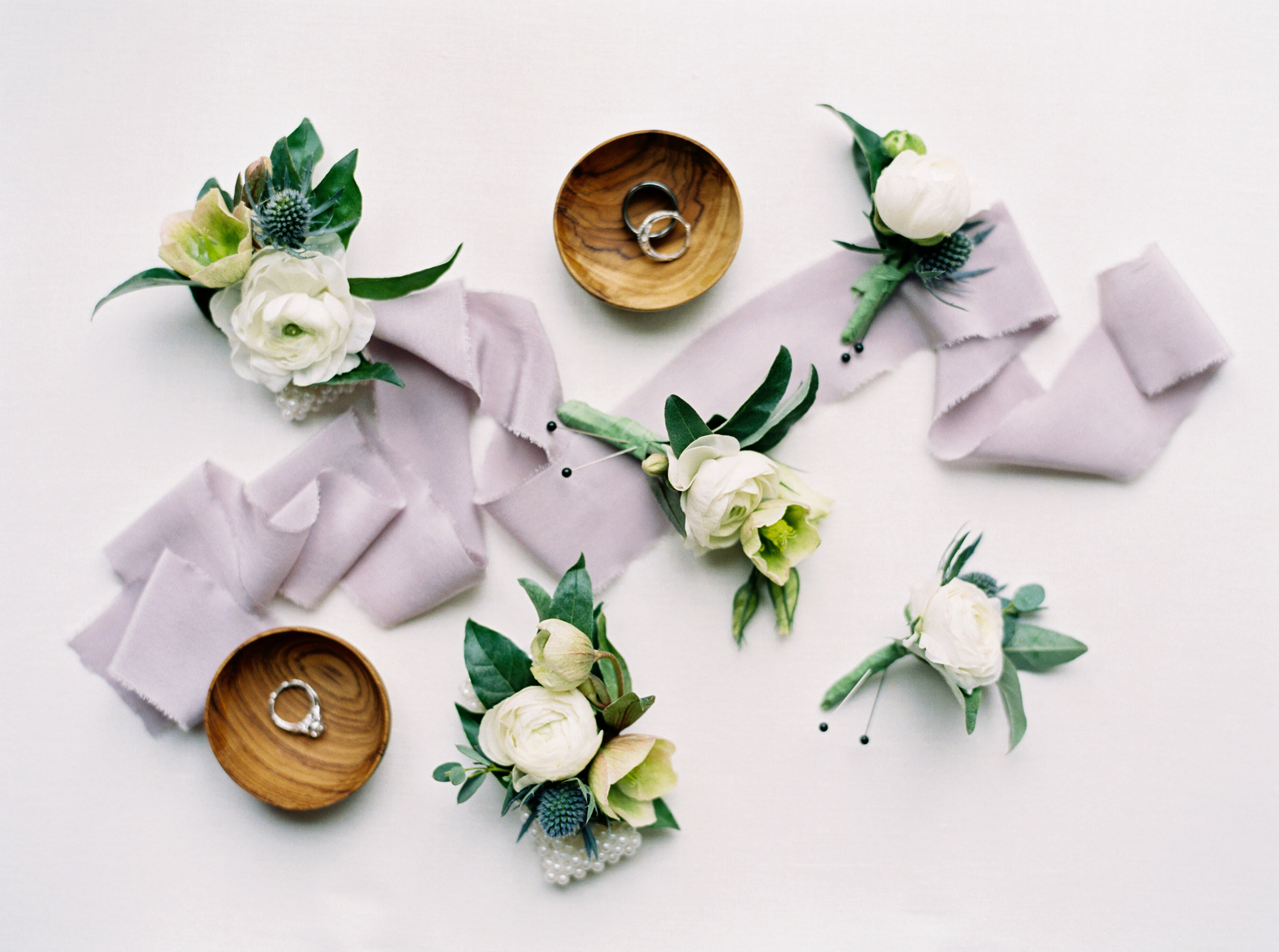 Boutonnières &amp; Corsages - Pin-on boutonnières, pin-on corsages and wrist corsages, for pickup only. For the pin-on variety, stem wrap will be in classic green floral tape as a standard. For a wrist corsage, please specify age of the recipient, as we can either design on ribbon or a metal cuff to accommodate different wrist sizes.  Please specify color requests and any other pertinent details.  Photos are examples only, designs vary with seasonally available blooms.  We recommend scheduling your pick-up no sooner than 6-8 hours before your event in order to maintain the freshness of the blooms.  Choose Standard for a boutonnière, Deluxe for a pin-on corsage, and Premium for a wrist corsage.  Photography credits: (1 &amp; 2) Nikki Santere Photography, (3) Victoria Heer Photography, (4) Tom Daly Photo, and (5) Lindsey Zovko Photography
