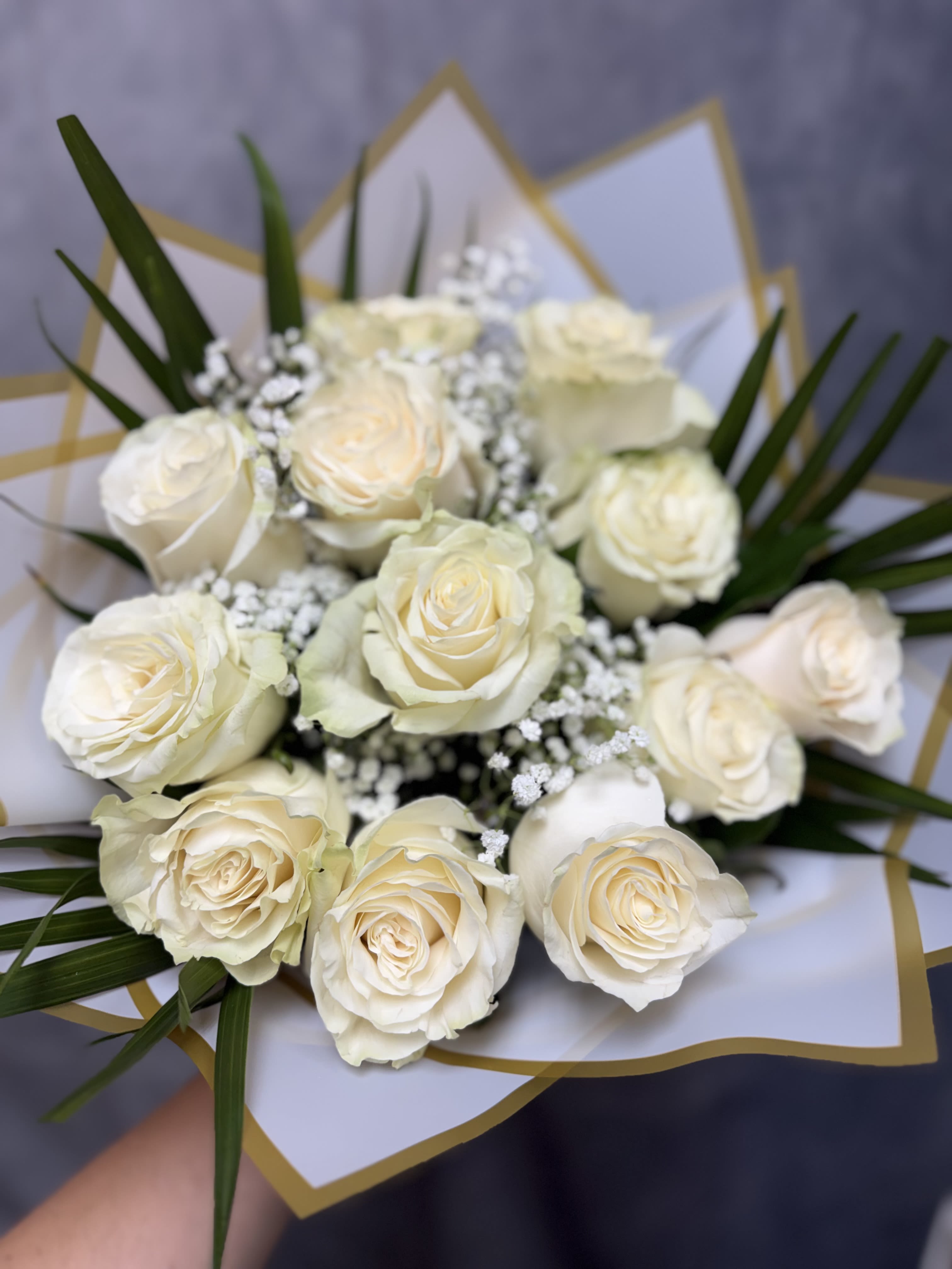 White Roses Bouquet  - Introducing our white roses bouquet, beautifully made with white roses, baby's breath, and greenery and wrapped with ribbons