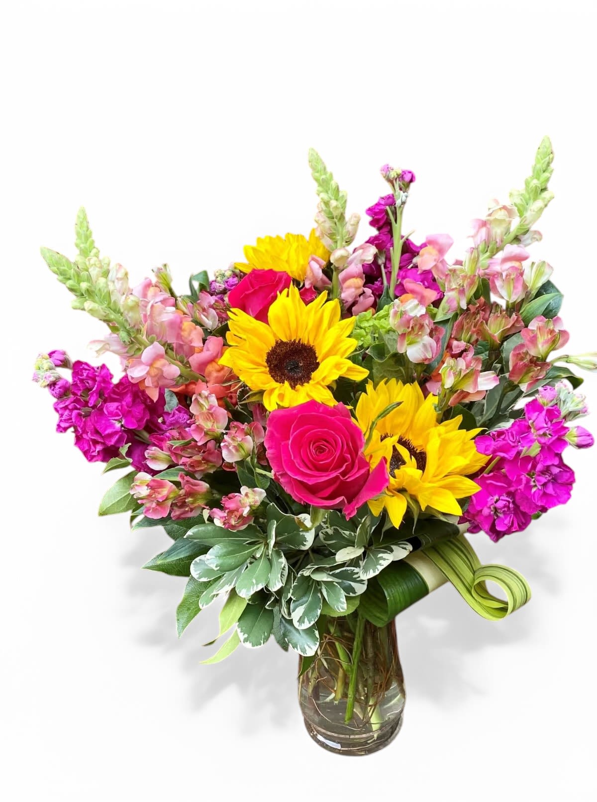 Celebration Vase  - An upright bright and cheerful arrangement the perfect addition to any celebration. Featuring sunflowers, snapdragons, stock flower &amp; roses.