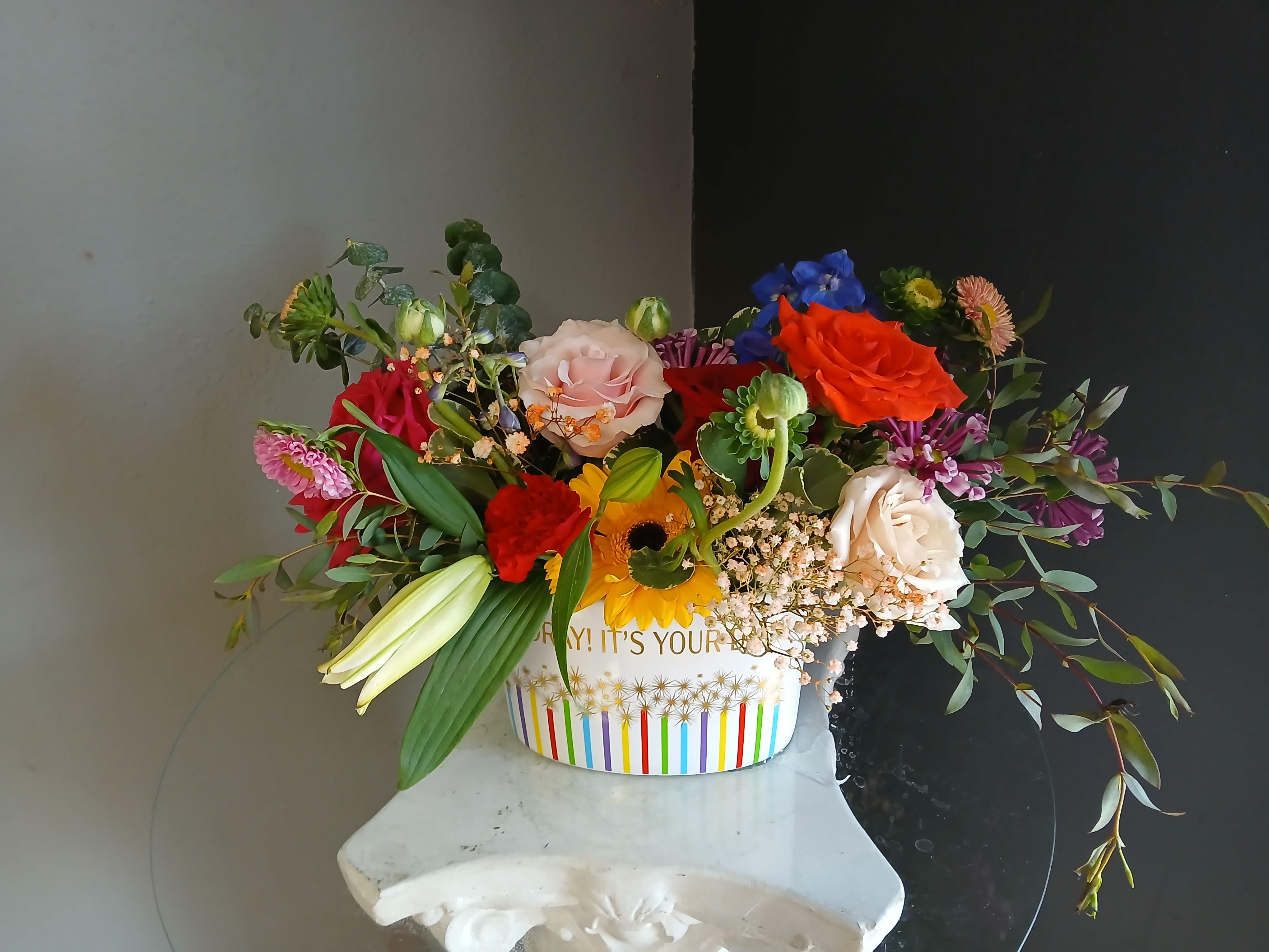 #744 Designer's Choice  - This beautiful flower arrangement of fresh mixed seasonal blooms is made by local designers in the heart Orange California. Hand crafted and perfect for a birthday. Can be sent as a local delivery or in-store pickup. This is an original, one of a kind arrangement. Order now before it's too late! 