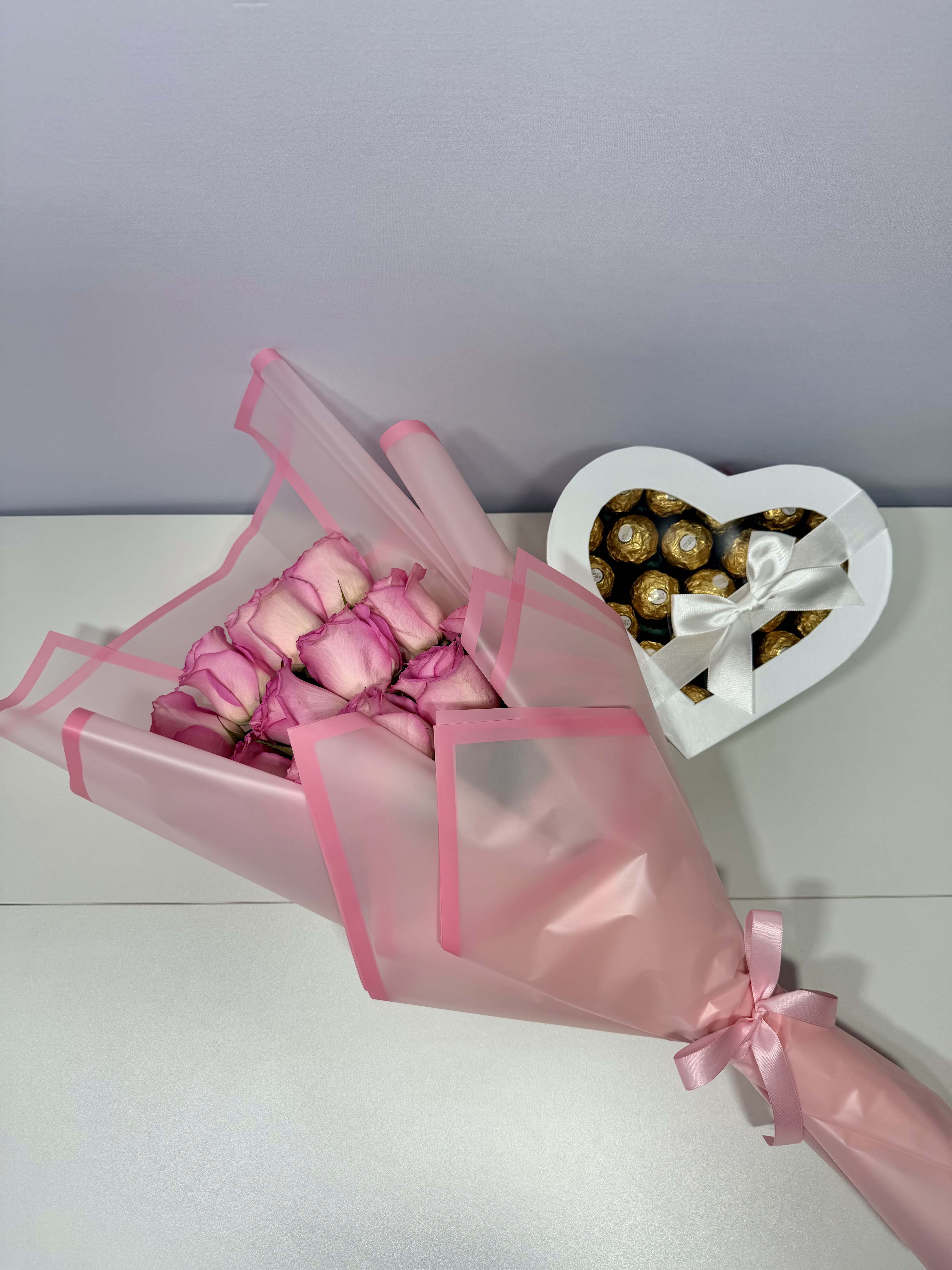 Rosé Love  - Delicate blush roses wrapped in soft pink paper and paired with a heart-shaped chocolate box — thoughtfully designed for sweet and memorable moments.